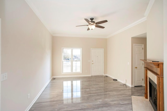 unfurnished living room featuring ceiling fan, light wood-type flooring, and ornamental molding