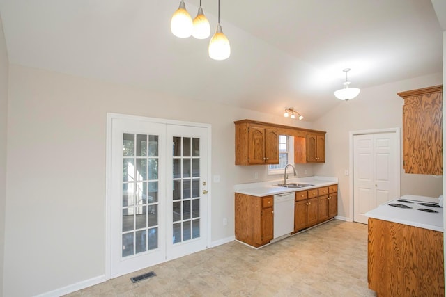 kitchen featuring decorative light fixtures, dishwasher, sink, and vaulted ceiling