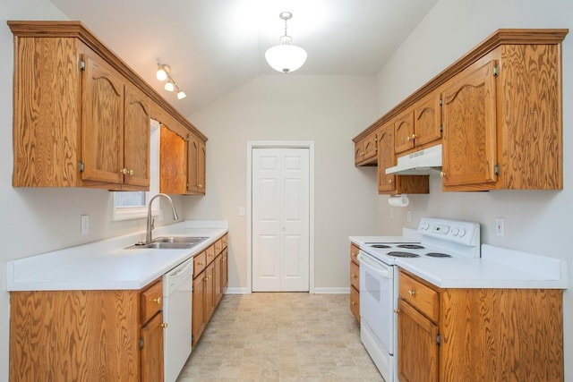 kitchen featuring white appliances, sink, and vaulted ceiling