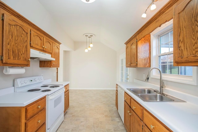 kitchen with lofted ceiling, white appliances, and sink