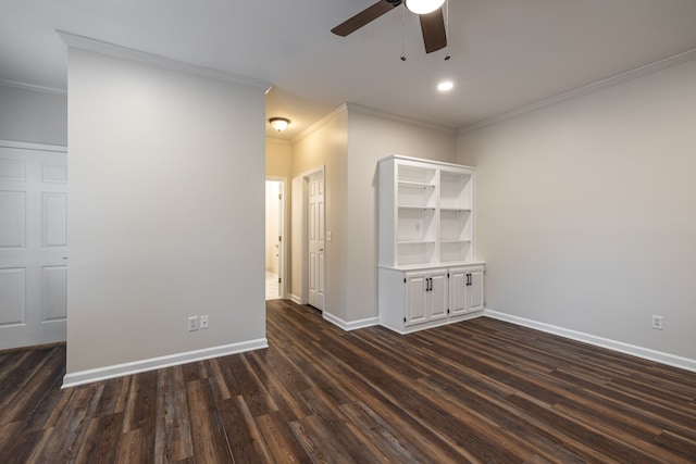 empty room featuring ceiling fan, crown molding, and dark hardwood / wood-style flooring