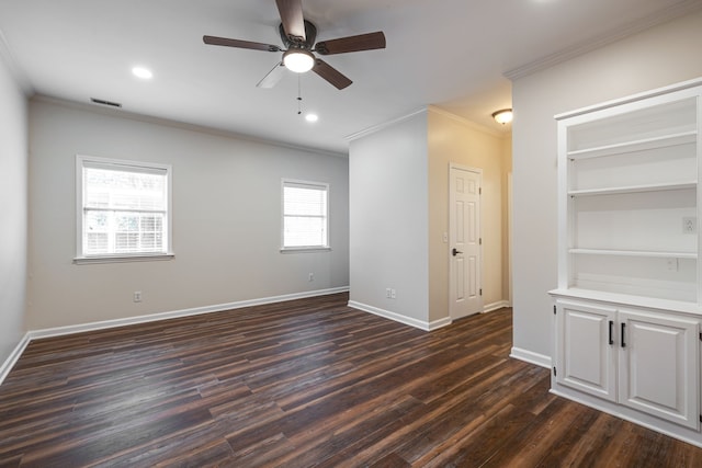 unfurnished room with dark hardwood / wood-style flooring, a wealth of natural light, and ornamental molding