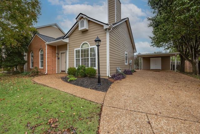 view of front of property with a carport and a front lawn