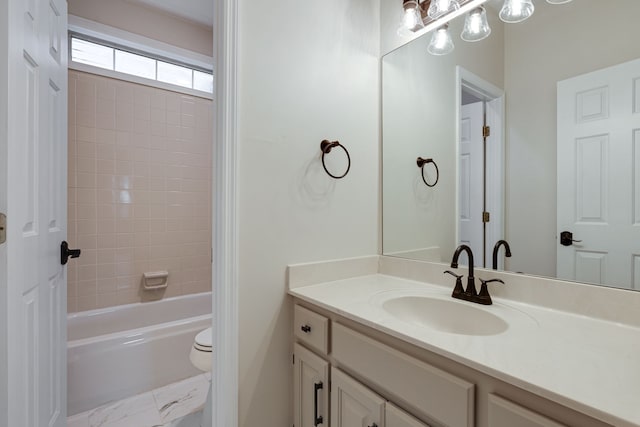 full bathroom with toilet, vanity, and tiled shower / bath