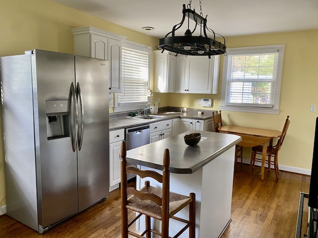 kitchen with white cabinets, stainless steel refrigerator with ice dispenser, pendant lighting, and dark wood-type flooring