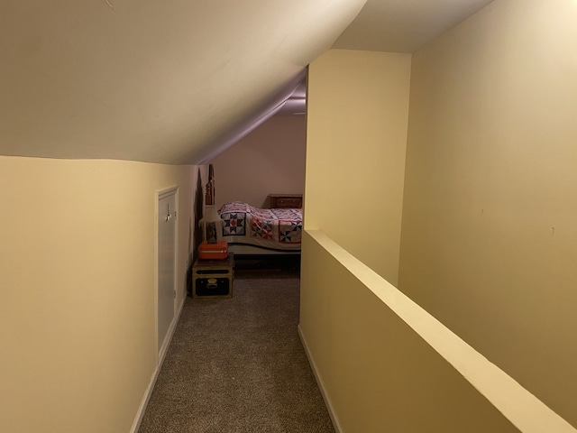 corridor featuring carpet floors and lofted ceiling