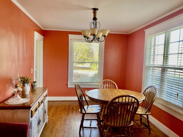 dining space featuring ornamental molding, dark hardwood / wood-style flooring, and a notable chandelier