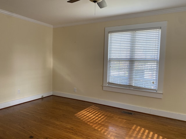 unfurnished room featuring ceiling fan, dark hardwood / wood-style floors, and crown molding