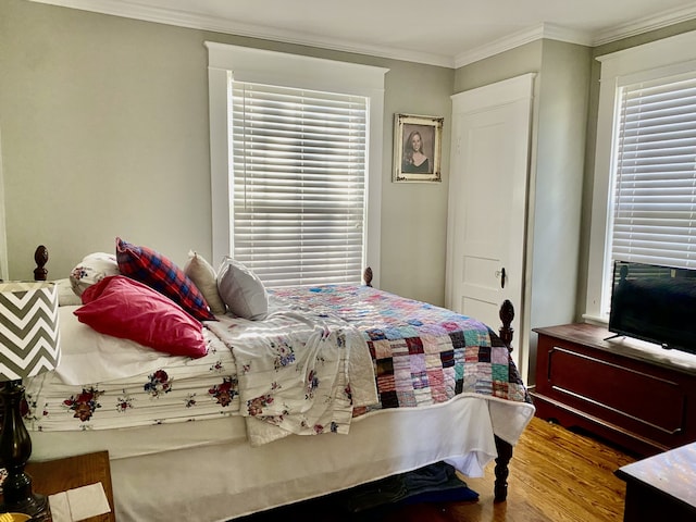 bedroom featuring hardwood / wood-style flooring and ornamental molding