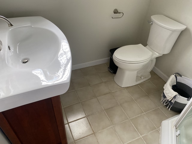 bathroom with toilet and tile patterned flooring