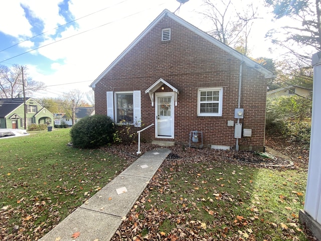 bungalow-style home with a front yard