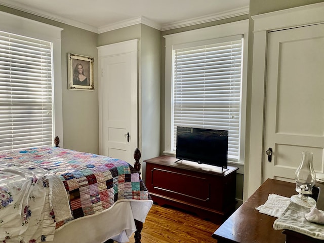 bedroom featuring ornamental molding and dark hardwood / wood-style floors