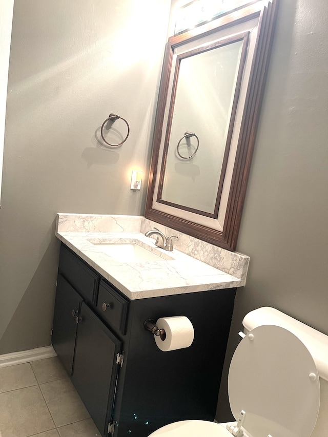 bathroom featuring tile patterned floors, toilet, and vanity