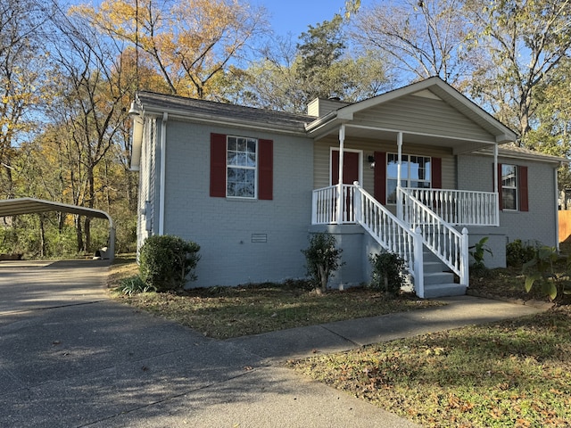 view of front of home featuring a carport and covered porch