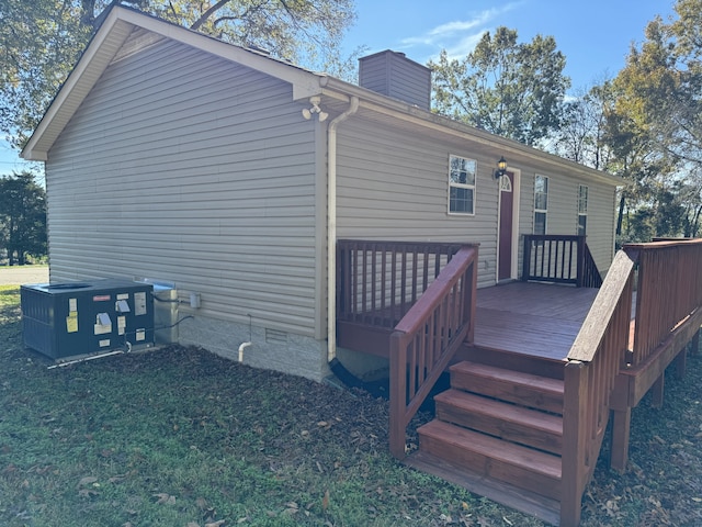 back of house with a wooden deck and central AC