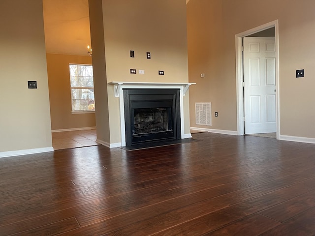 unfurnished living room featuring dark wood-type flooring