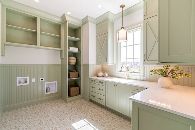 kitchen with a sink, hanging light fixtures, open shelves, and light countertops