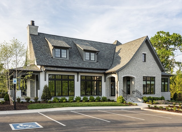 view of front of property with uncovered parking and a chimney