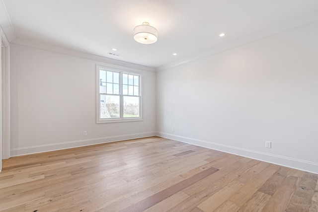 unfurnished room with light wood finished floors, recessed lighting, visible vents, ornamental molding, and baseboards