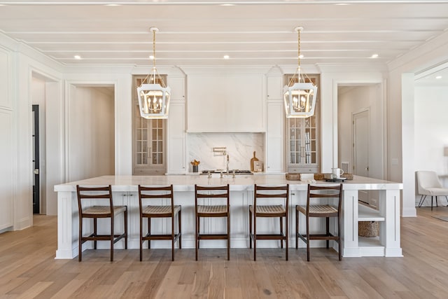 kitchen featuring a kitchen bar, pendant lighting, and a notable chandelier