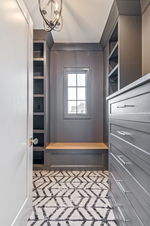 walk in closet featuring a chandelier