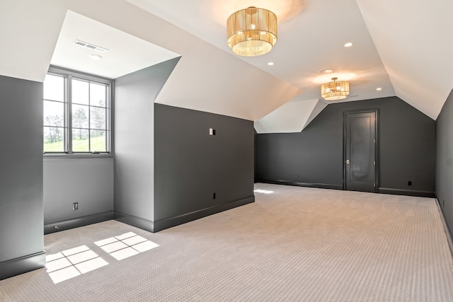 additional living space featuring recessed lighting, visible vents, light carpet, vaulted ceiling, and baseboards