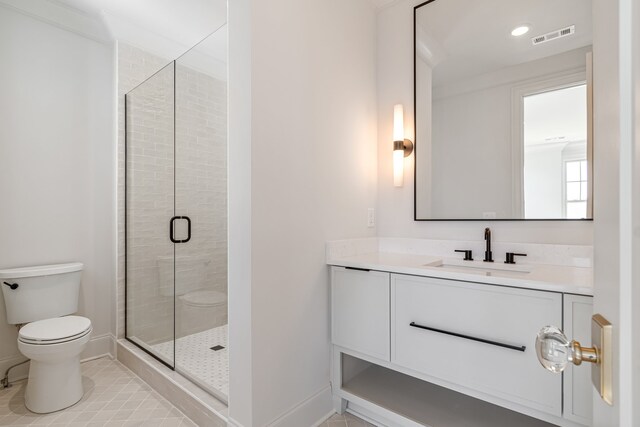 bathroom featuring toilet, visible vents, baseboards, a shower stall, and tile patterned floors