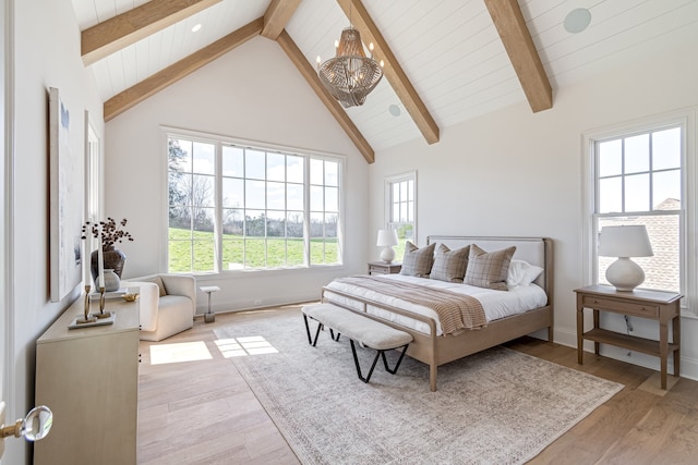 bedroom featuring light wood-type flooring, high vaulted ceiling, a notable chandelier, and beamed ceiling