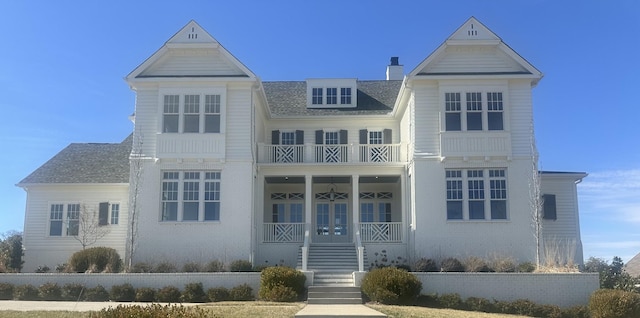 view of front of property with a chimney and brick siding