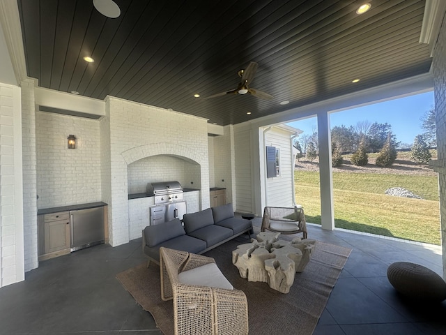 view of patio / terrace featuring an outdoor kitchen, a grill, and a ceiling fan