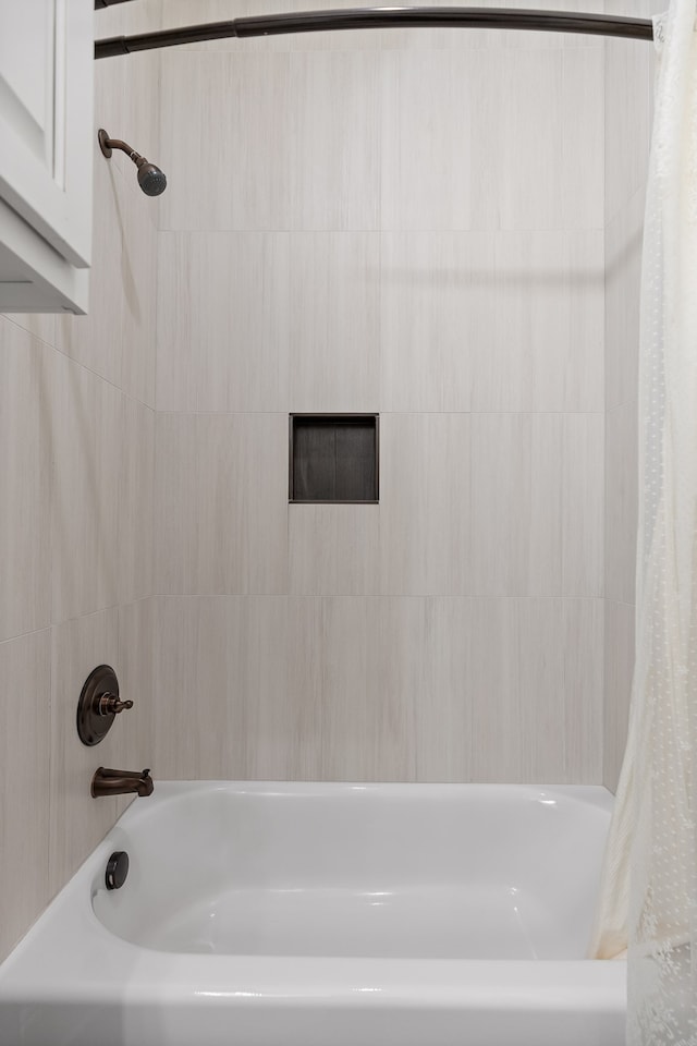 bathroom with shower / bath combo with shower curtain