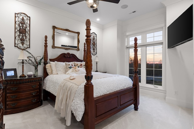 bedroom with ornamental molding, light colored carpet, and ceiling fan