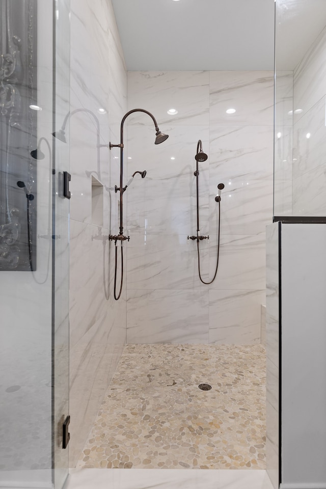 bathroom featuring a shower with shower door