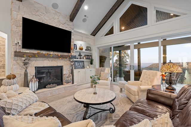 living room with a fireplace, french doors, beam ceiling, and high vaulted ceiling