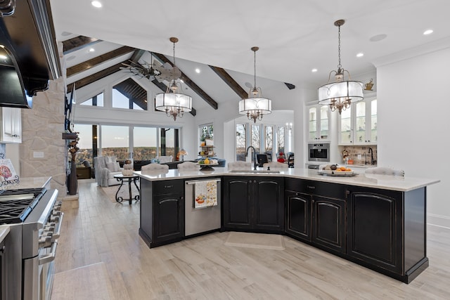 kitchen with appliances with stainless steel finishes, beam ceiling, pendant lighting, sink, and light hardwood / wood-style floors