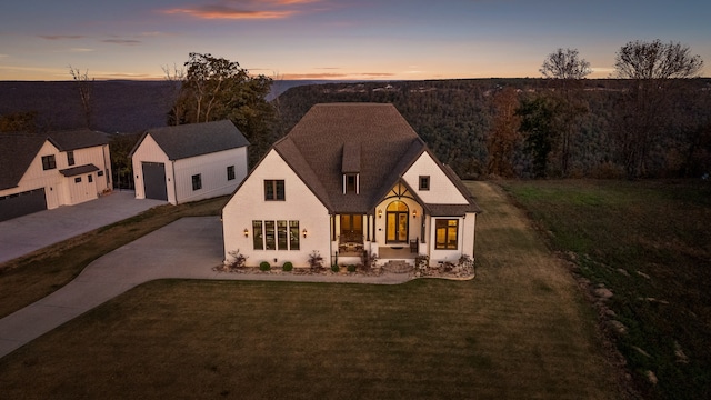 view of front of house featuring a garage and a lawn