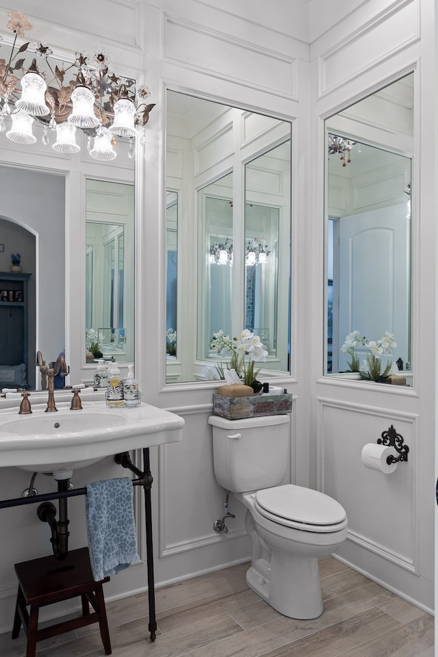 bathroom featuring hardwood / wood-style floors and toilet