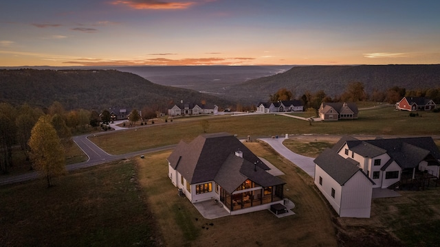 aerial view at dusk featuring a mountain view