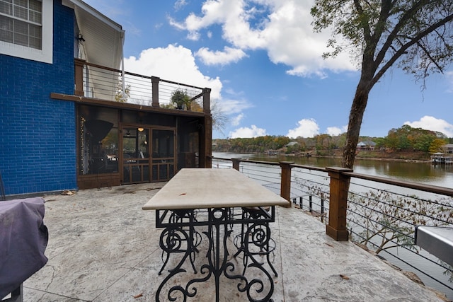 view of patio with a balcony and a water view