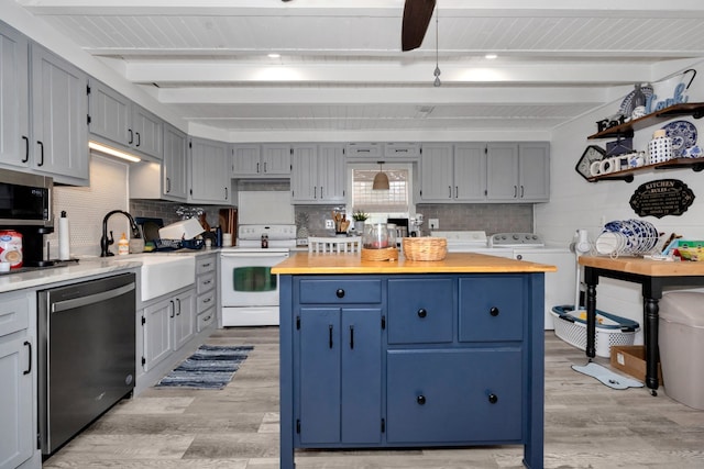 kitchen featuring butcher block counters, white range with electric stovetop, light hardwood / wood-style floors, stainless steel dishwasher, and independent washer and dryer