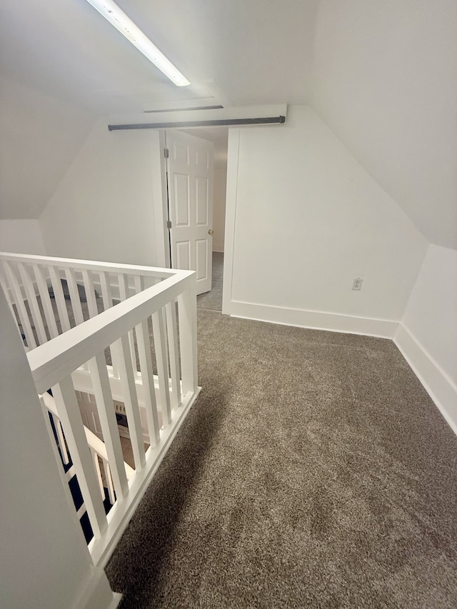 additional living space featuring lofted ceiling and carpet