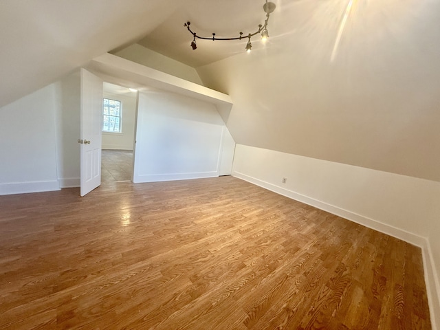 bonus room featuring wood-type flooring and lofted ceiling