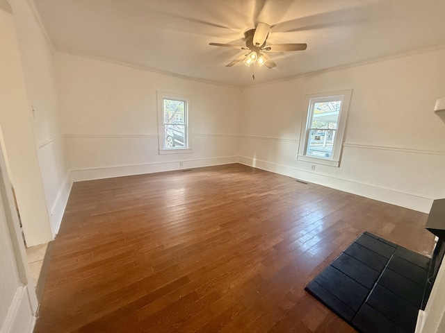 unfurnished room with ceiling fan, dark hardwood / wood-style floors, and ornamental molding