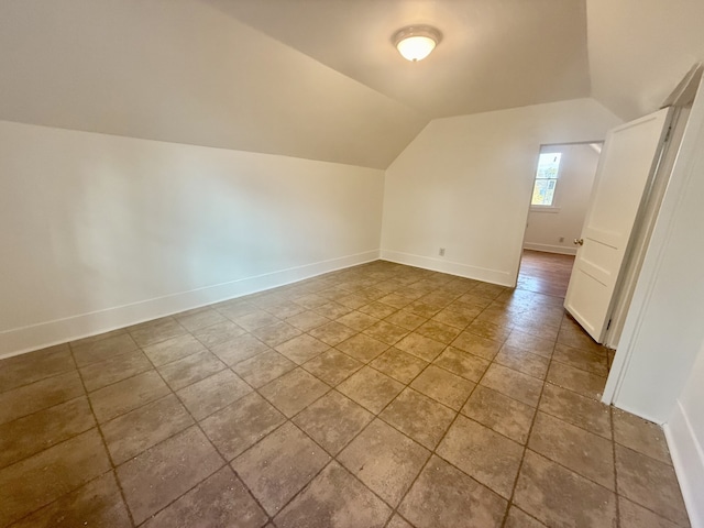 additional living space featuring vaulted ceiling