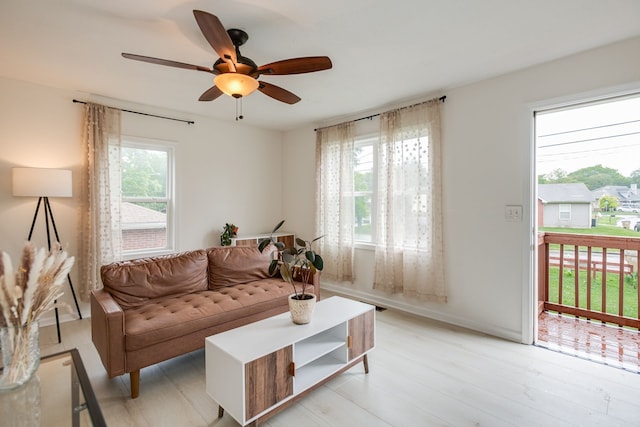 living room featuring ceiling fan, a healthy amount of sunlight, and light hardwood / wood-style flooring