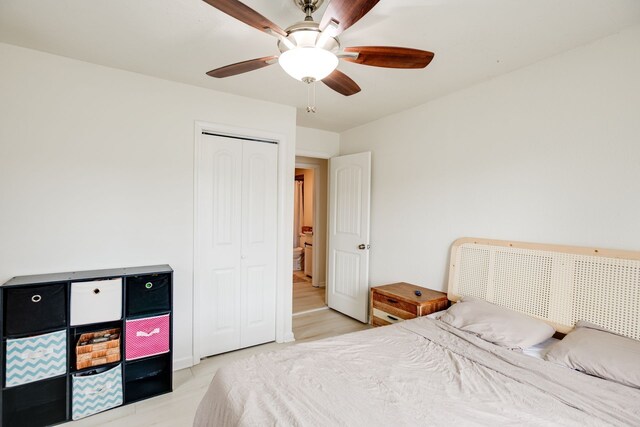 bedroom featuring ceiling fan, a closet, and light wood-type flooring