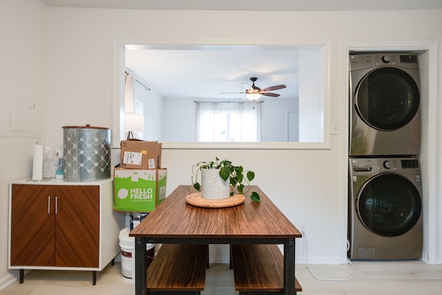 washroom with stacked washer / dryer, ceiling fan, and light hardwood / wood-style floors