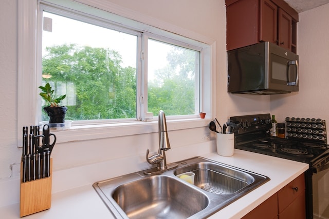 kitchen with sink and black range