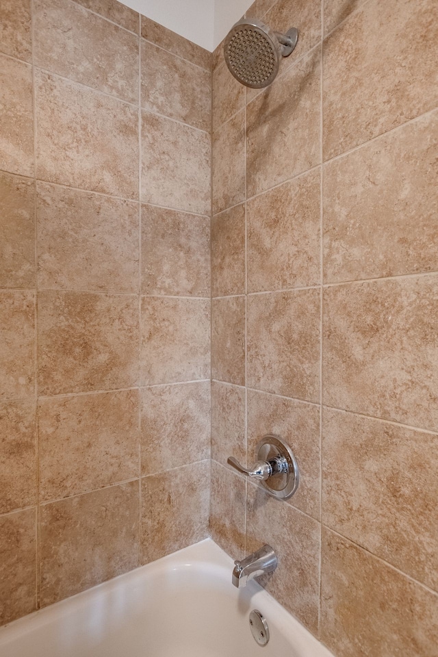 details with tiled shower / bath combo