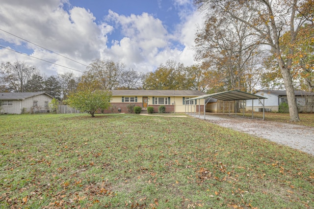 ranch-style home featuring a carport and a front yard